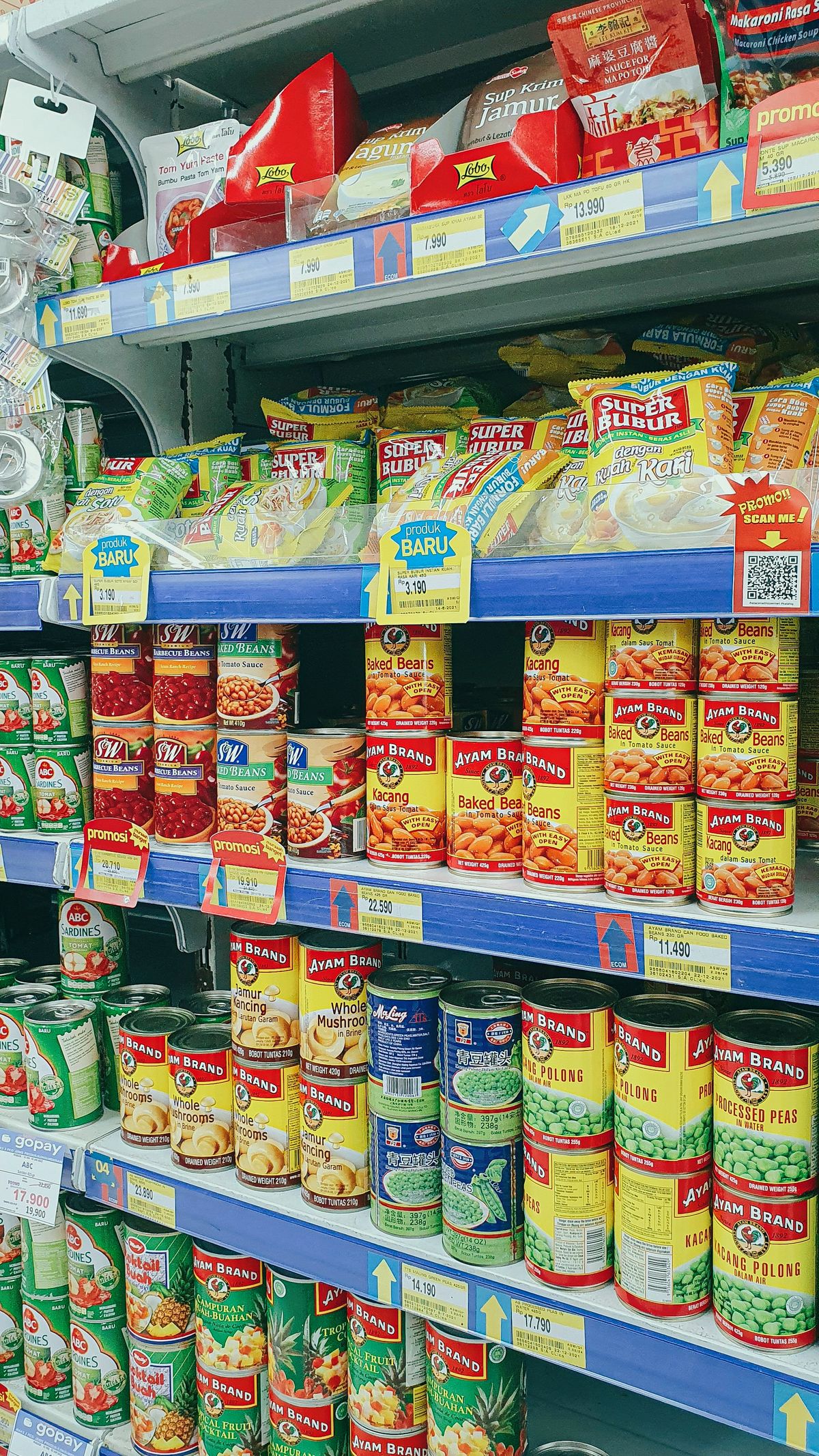 Tinned and packaged grocery goods stacked on wholesale shelving